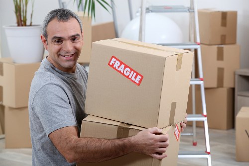 Removal van and moving boxes in a Redbridge residential street