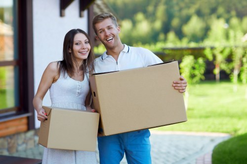 Professional movers loading furniture into a van for a Redbridge move