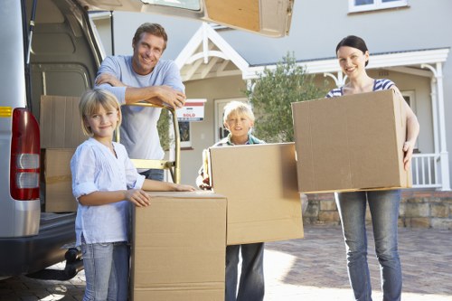 Professional movers packing and protecting household items for a Redbridge home relocation