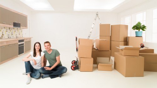 Local movers loading household items carefully into a van